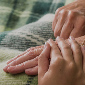 elderly hand holding hands