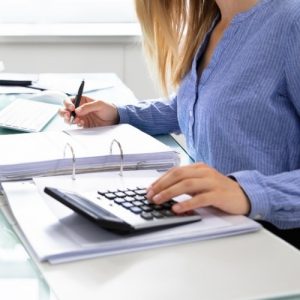 woman using pen and calculator